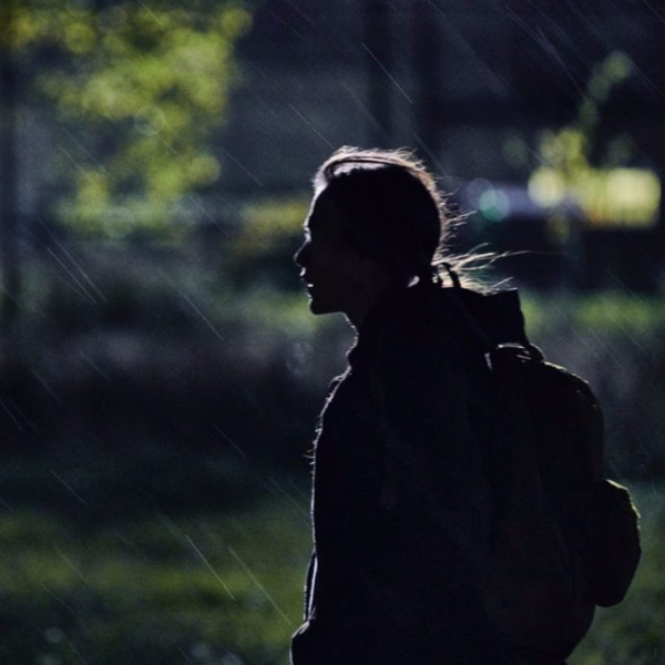 A women standing in the rain at night