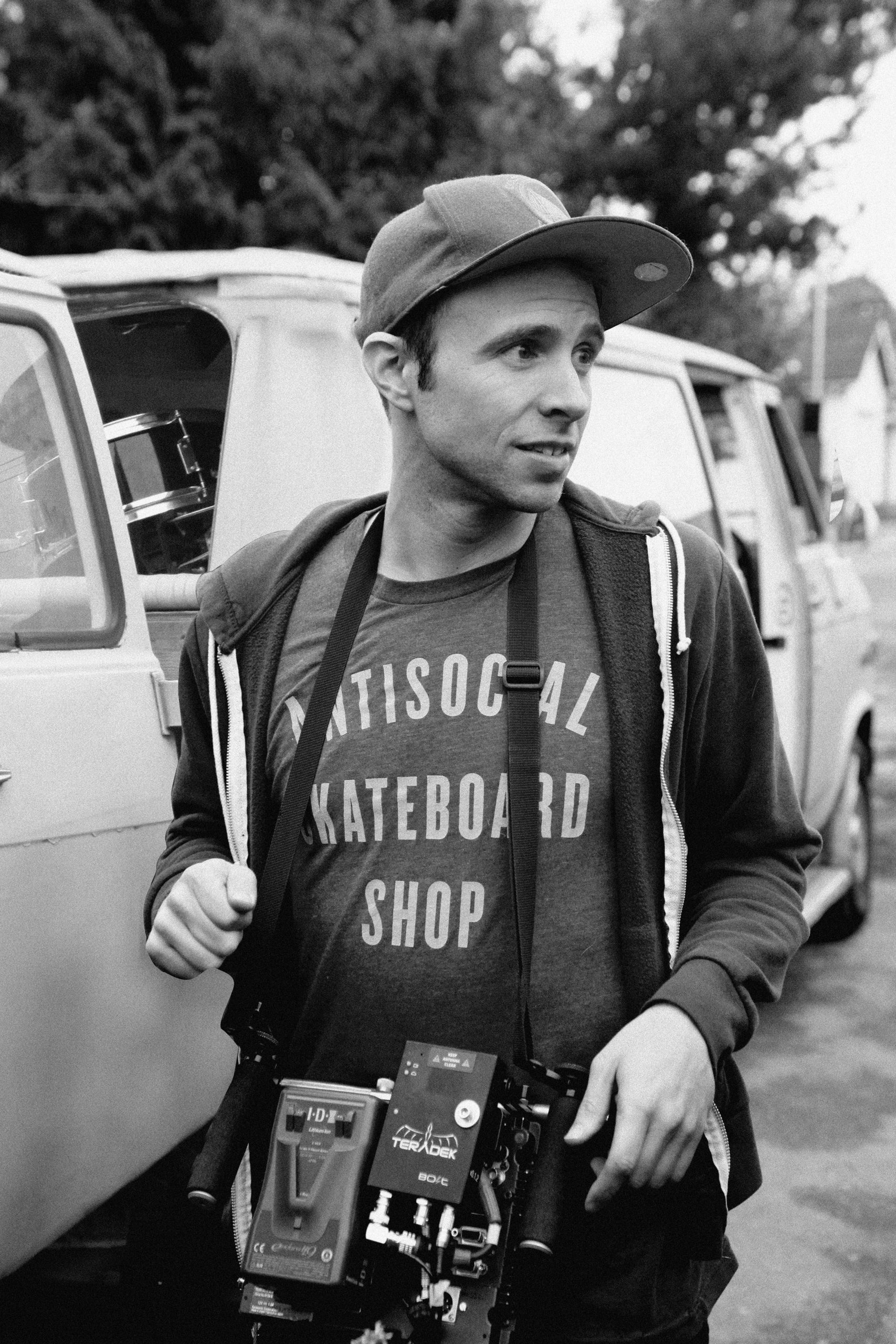 Black and white photo of a man with a camera.