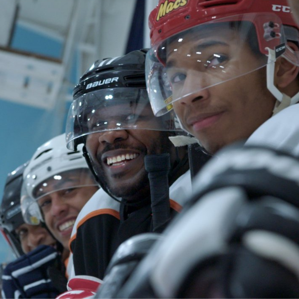 Shot of a group of young boys sitting on the hockey bench.