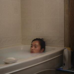 NO CRYING AT THE DINNER TABLE Hazy photo of a young girl laying in a bathtub with the water up to her mouth