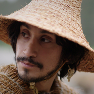 Close up photo of a man wearing a straw hat