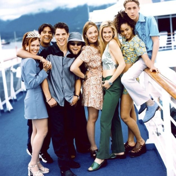 Group of teenagers standing together on the deck of a boat