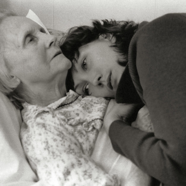 LIFE CLASSES Black and white image of a young girl laying down and hugging and older lady